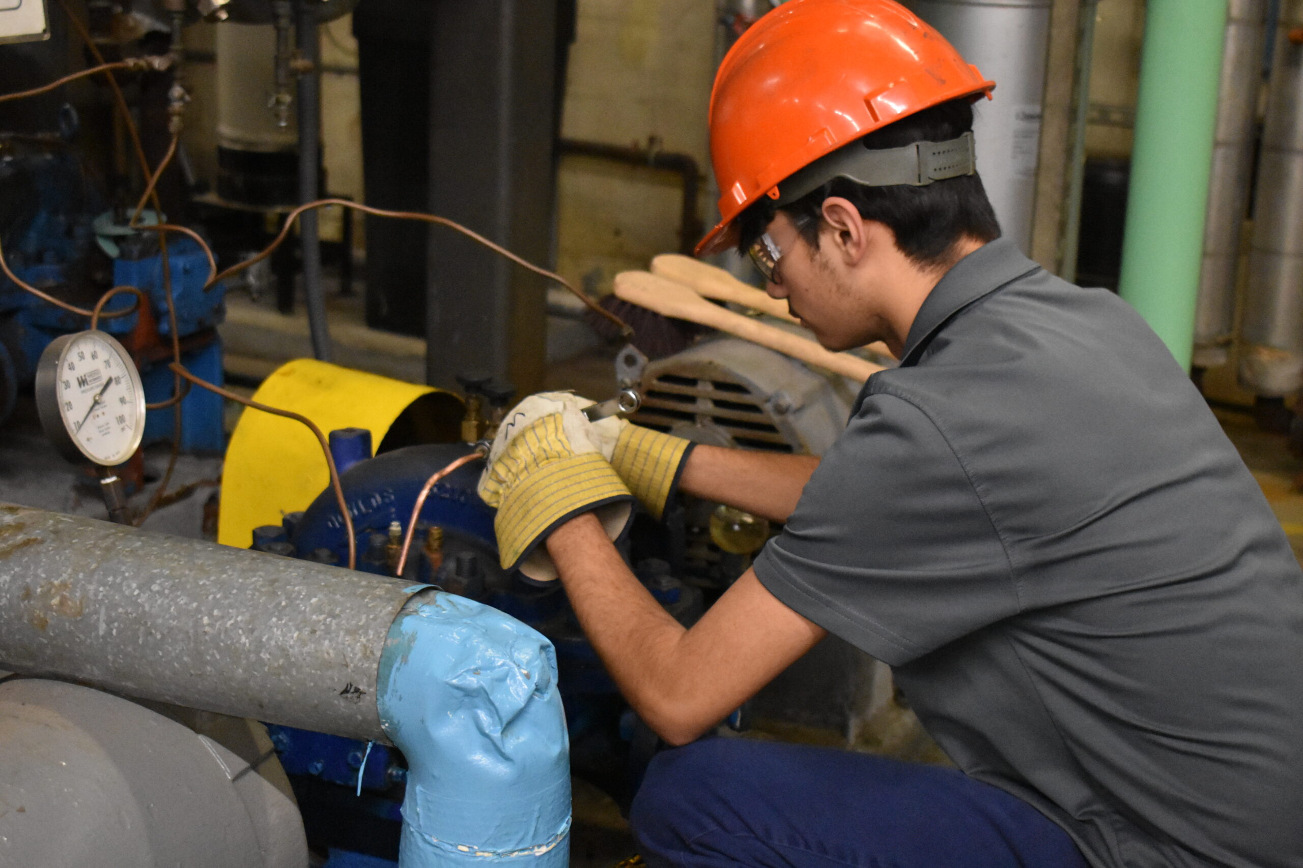 STEAM Student performing pump maintenance